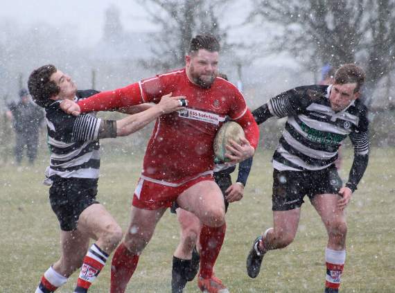 Sam Smith battles his way through the snowy conditions for a try