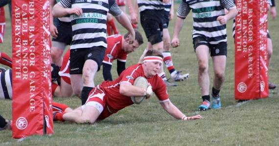 Rhodri Walters crashes in for a try