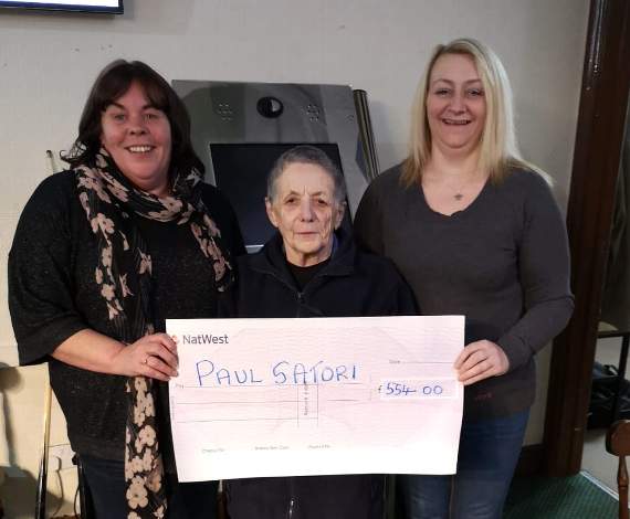 Ruth Barnes of Paul Sartori Narberth receives a cheque from Ann Marie Owen and Anne Lonsdale of the Narberth and District Ladies Darts league.