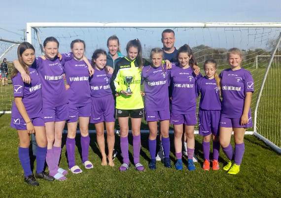 Under 14s pictured with the runners up trophy with their coaches Carrie and Geraint.
