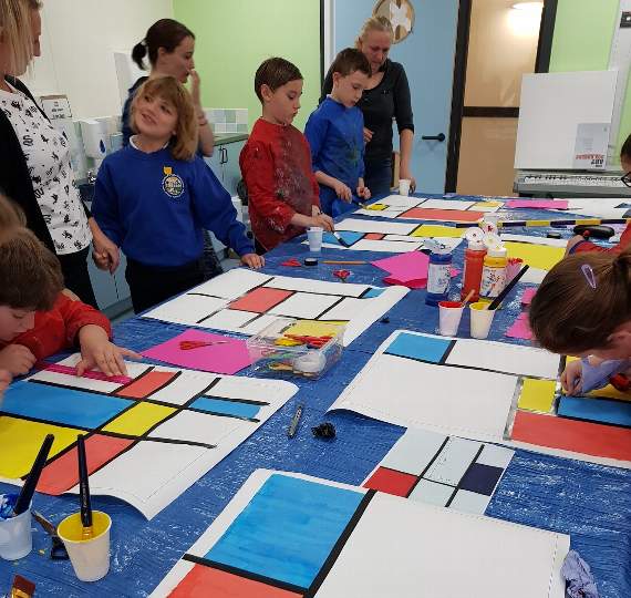 Pupils and staff working on the design of the mosaic