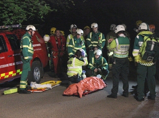 999 crews tend to the rescued climber at Symonds Yat as darkness falls.