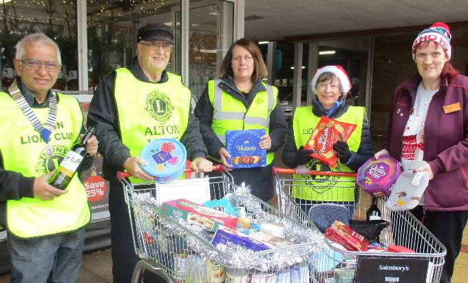Atul Patel receives gifts from Sainsbury’s charity co-ordinator Debby Bridger, watched by Lions John Partridge, Annette Mill and Moira Baker