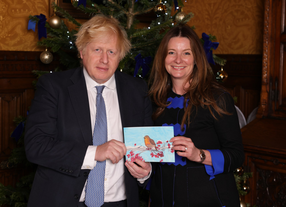 Gillian Keegan MP with Prime Minister, Boris Johnson – with the MP’s 2021 Christmas card designed by Ione. Picture by Andrew Parsons / Parsons Media