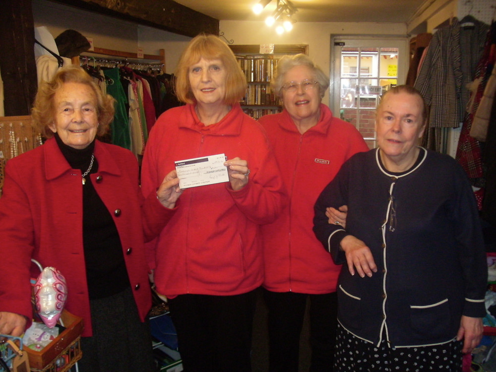Lady Tindle (left) and volunteers donate a £1,000 cheque to charity Speakability, one of many beneficiaries, in 2014