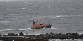 Rowers rescued after their boat capsized in gale force winds