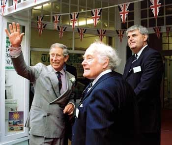 Proprietor Sir Ray Tindle CBE and editor Neil Dickinson look on as a smiling Prince Charles waves to the crowds before undertaking a tour of the Tenby Observer offices.
Pic. Malcolm Richards Photography