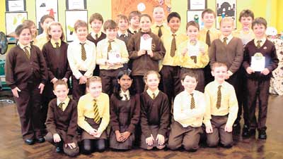 Class 4 pupils proudly show the CAFOD gifts purchased by their fund-raising to help others less fortunate than themselves.