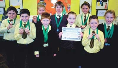 Pupils with their medals and trophies achieved at the Tenby Dolphins Club Championships.