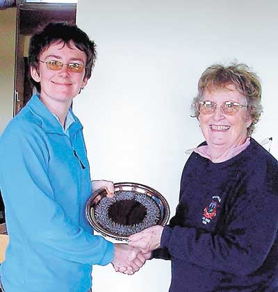 Winner Laura McQueen (left) receives the salver from Ann Marsden.