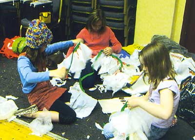 Making Munchkin costumes by recycling plastic bags.