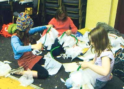 Making Munchkin costumes by recycling plastic bags.