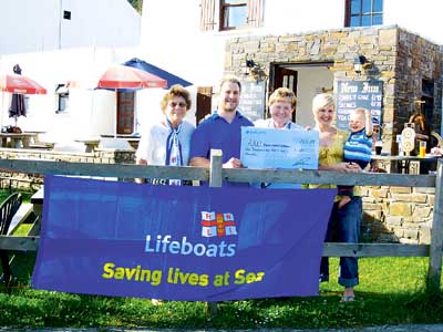 Paul and Leanne, of the New Inn, with their son Alfie, are pictured presenting Gerry Brutnell and Pam Mortimer, of the Saundersfoot branch of the RNLI, with a cheque for £1041.