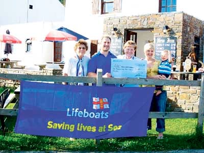 Paul and Leanne, of the New Inn, with their son Alfie, are pictured presenting Gerry Brutnell and Pam Mortimer, of the Saundersfoot branch of the RNLI, with a cheque for £1041.