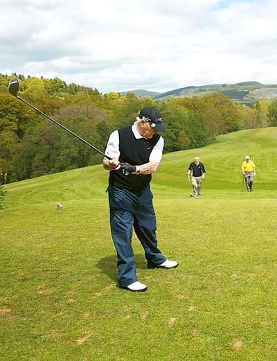 Owen Monaghan practices his swing on the highest tee on the course.