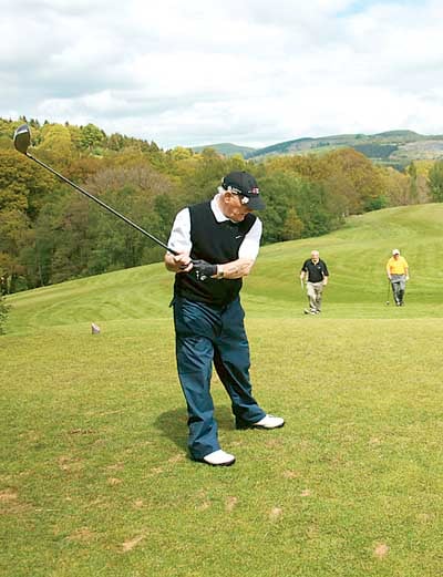 Owen Monaghan practices his swing on the highest tee on the course.