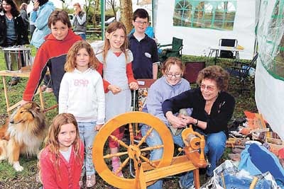 Gerry Brutnell teaching the art of wool spinning to Zach, Gareth, Isabella, Kitty, Emily and Izzie.