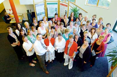 Clr. Huw George and Rosemary Griffiths (front right) are pictured with the award-winning school teams.