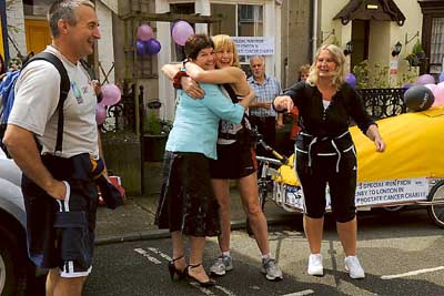 A hug from the Mayor, Clr. Mrs. Sue Lane before Rosie sets off to London, while looking on are friends Steve and Tracey Thomas who ran with her for the first few miles.