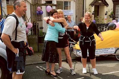 A hug from the Mayor, Clr. Mrs. Sue Lane before Rosie sets off to London, while looking on are friends Steve and Tracey Thomas who ran with her for the first few miles.