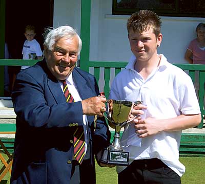 Winner Ryan Thomas receives the cup from club president, John Evans.