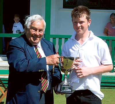 Winner Ryan Thomas receives the cup from club president, John Evans.