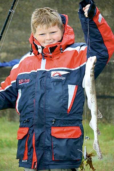 A proud young angler showing off his catch.