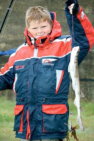 A proud young angler showing off his catch.
