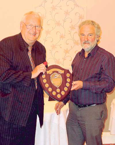 Roy Packer (left) being presented with the Milton Farm Eggs Challenge Shield by John Thomas, formerly of Milton Farm Eggs.