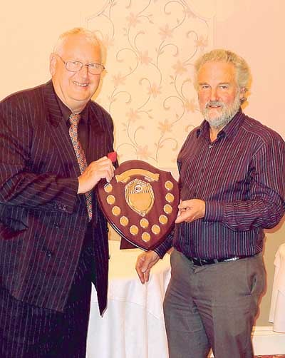 Roy Packer (left) being presented with the Milton Farm Eggs Challenge Shield by John Thomas, formerly of Milton Farm Eggs.