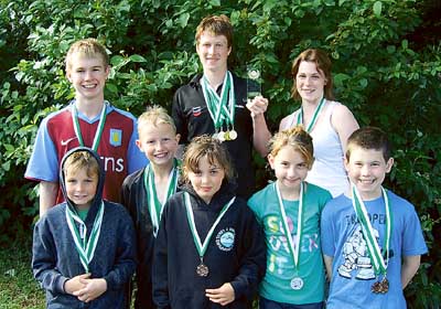 Katie lines up for a photo with Tenby’s IM finalists Matt, Henry, Heather, Luke, Harry, Talia and Gareth at the Amman Valley Sprint Meet 2009.
