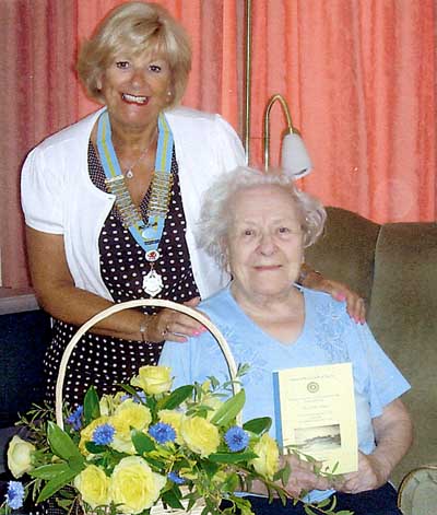 Lillian received a basket of flowers from district chairman Toni.