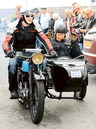Turning back the clock, John Adams is given the passenger seat by his great-nephew, 19-year-old James Adams. John, now 86 years of age, along with his late brother, Henry, was among the founders and is one of the long-term riders of the Saundersfoot Run. They are seen aboard James’s 1929 Triumph NSD 550cc machine.  Pic. Malcolm Richards Photography