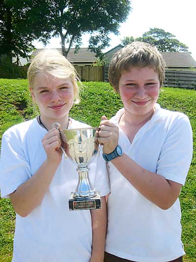At the swimming gala, the red team won and the team captains, Freddie Meyrick and Harriet Sleight, are seen with the cup.
