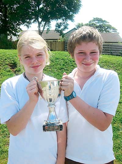 At the swimming gala, the red team won and the team captains, Freddie Meyrick and Harriet Sleight, are seen with the cup.