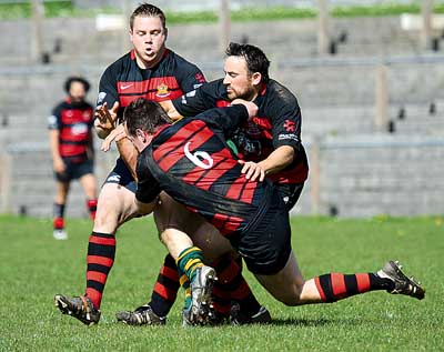 There’s a Cefneithin player somewhere in the middle of these three Tenby tacklers - just look at the socks!