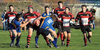 Burly number eight Sam Smith on the charge for United as three Aberaeron defenders move in to try and stop him breaking through. Pic. David Bolton