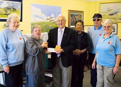Fundraising swimmer James Merriman is pictured giving a donation to John Brock, of Carew Control Tower.