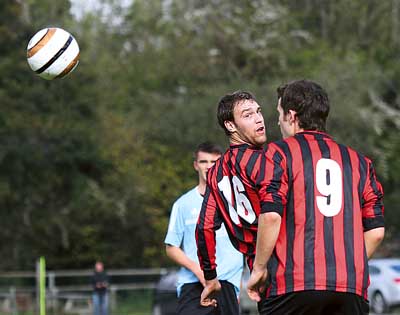 Danny Caine glances a header upfield for Saundersfoot in their game with Neyland on Saturday. Saundersfoot lost the match 3-1.