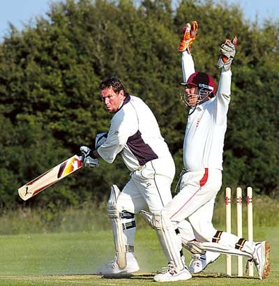 Wicket-keeper Ian Poole, of Saundersfoot, makes an unsuccessful appeal for the stumping of Ian Jenkins, of Lawrenny. Pic. Susan McKehon