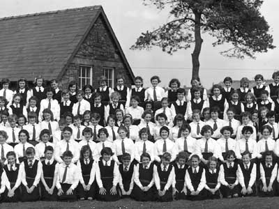 The classmates are seen together in this school photo taken back in 1960.