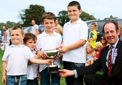 Young stockmen William, Evan, Dan and Jamie Davies are greeted by the show president, David John.