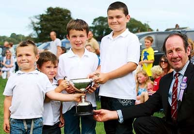 Young stockmen William, Evan, Dan and Jamie Davies are greeted by the show president, David John.