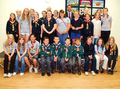 Tenby Guides, Brownies and Cub members, with their leaders, Mrs. Mo Crockford, Mrs. Margaret Peake, Mrs. Nicole Evans and Ms Jenny Perret, together with Rotary president Andy Tulley, are pictured following the cheque presentations at the Tenby Scout and Guide Hall last week.