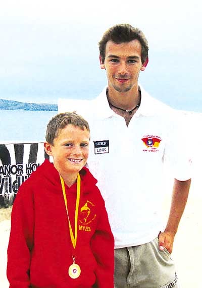 Saundersfoot’s Myles Johnson who won gold in the 1k run beating the current Welsh champion is pictured with his coach Angelo Fecci.