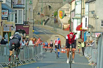 Crowds line the barriers as cyclists make their way through Pembroke’s Main Street during the bike leg of Sunday’s Ironman Wales.