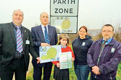 Pictured by the 20mph sign are (from left): Mark Owen, head of Orielton CP School; Clr. John Allen-Mirehouse; Nia Williams; Kirstie-Anne Donoghue, assistant road safety officer, and Jim Harwood, road safety trainer.