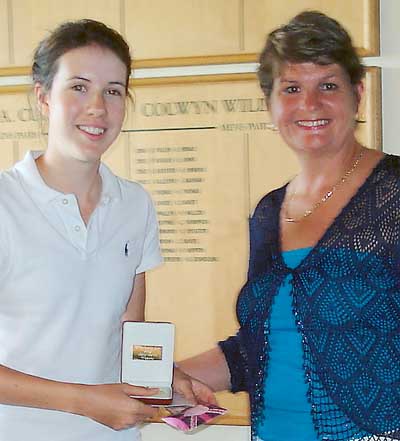 Bethan Morris, girls champion, receives her prize from Vicky Burks.