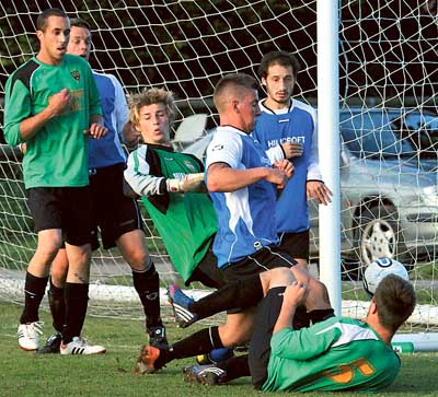 A goalmouth melee results in the ball slipping wide of the Saundersfoot post in Tuesday night’s division four match against Clarbeston Road, which the Seasiders went on to lose 3-1. Pic. Susan McKehon