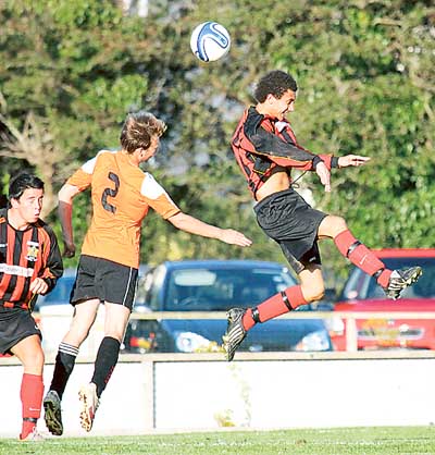 Jake Marsh and Daryl Mansbridge jump to challenge for the ball.